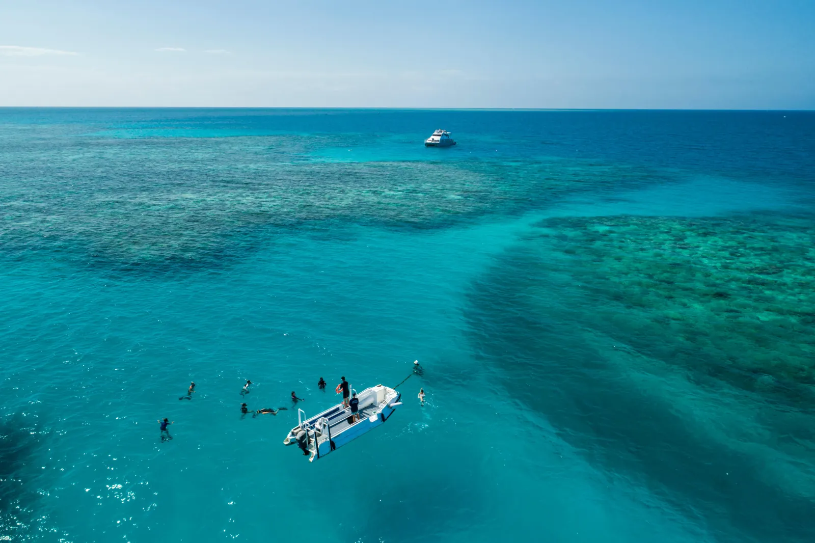 Aerial view of snorkellers and a dive tender over the reef