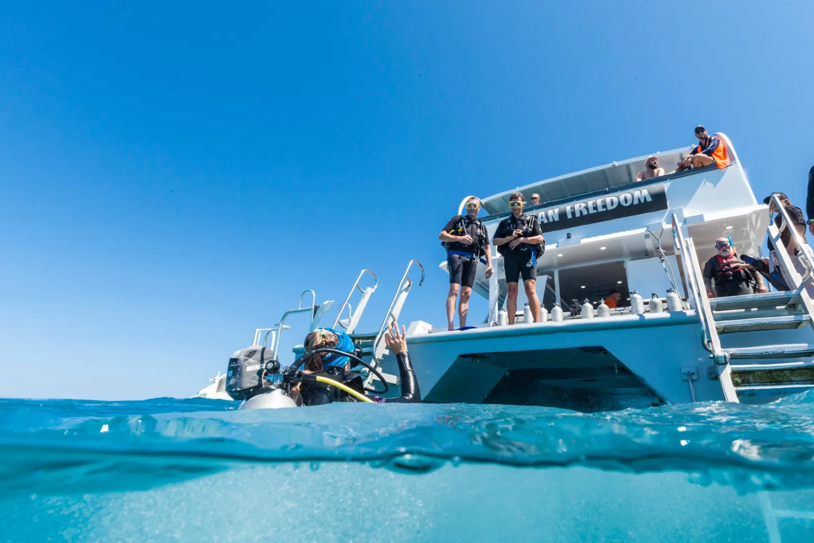 Reef boat moored with its swim platform lowered to the water