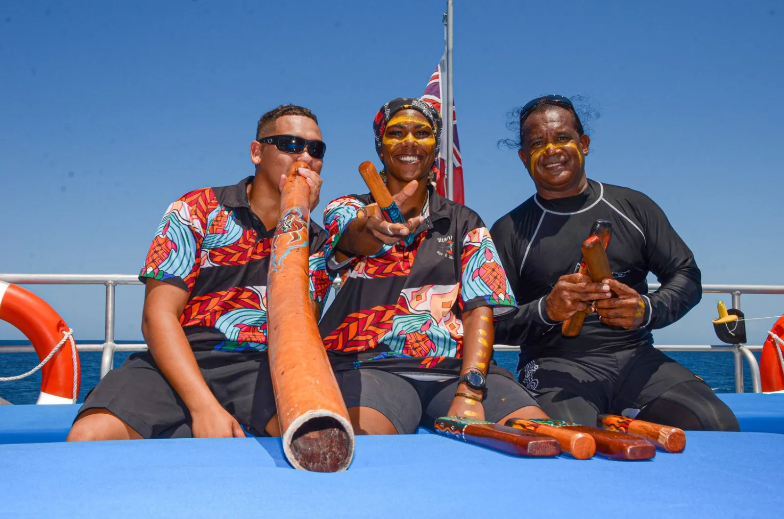 Indigenous crew members with a didgeridoo on deck