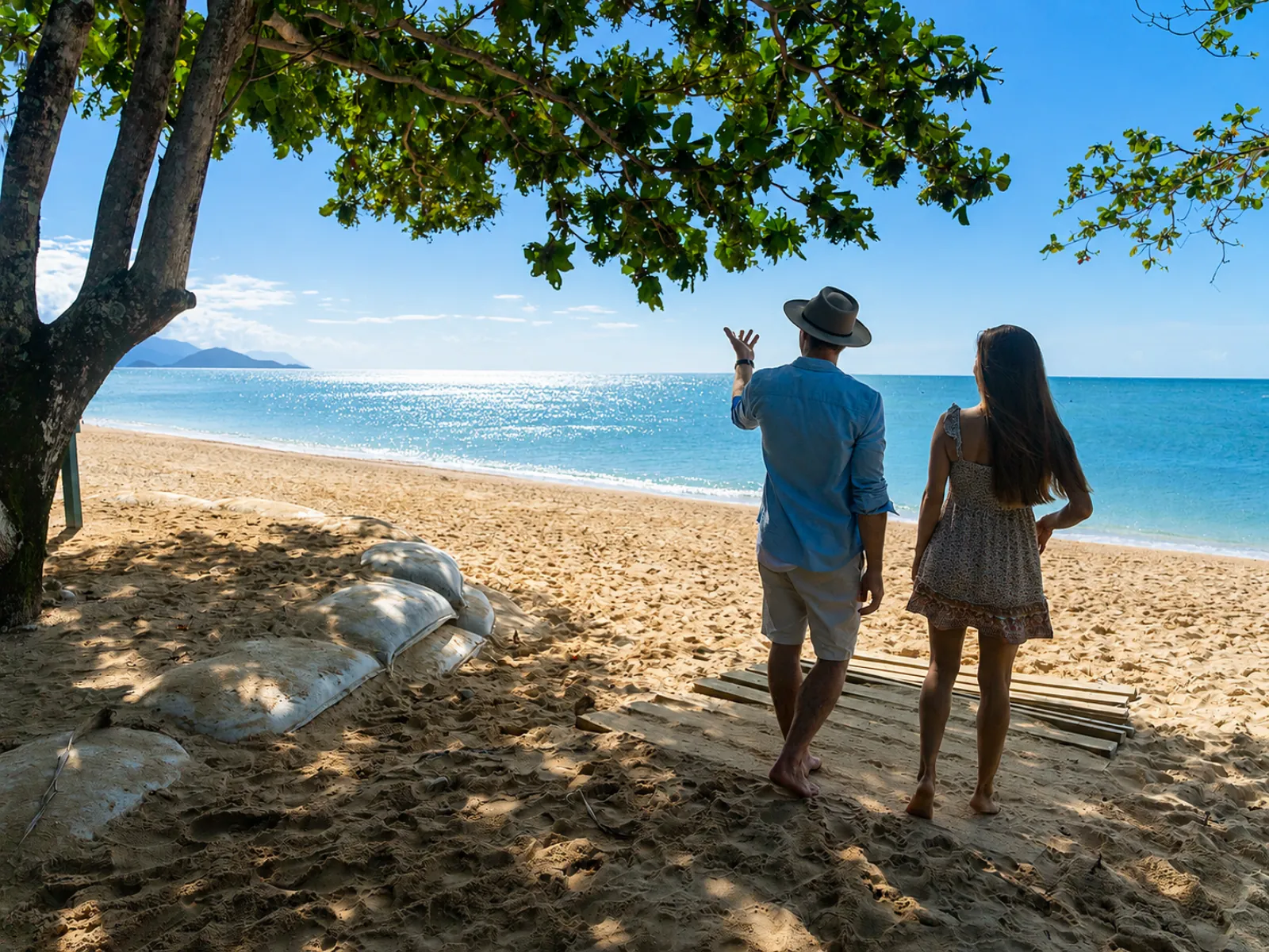 Couple walking on a Frankland Islands beach