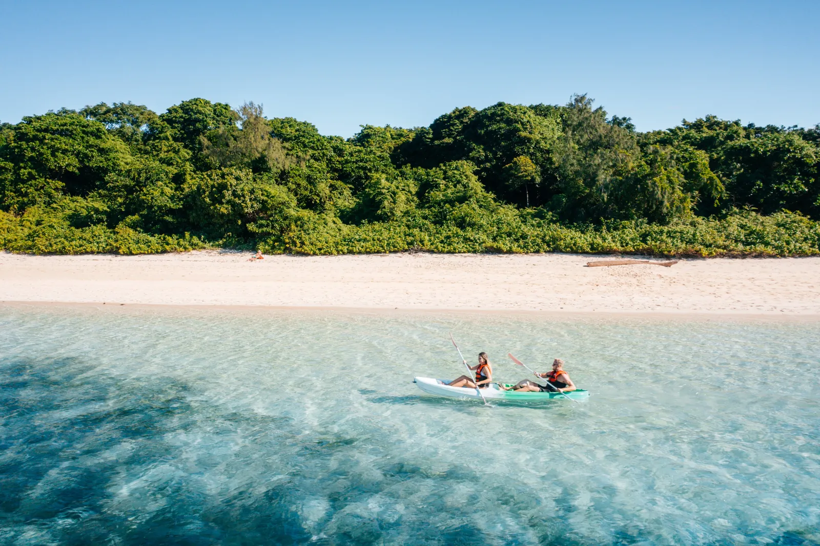 Green Island beach with canoes in the shallows