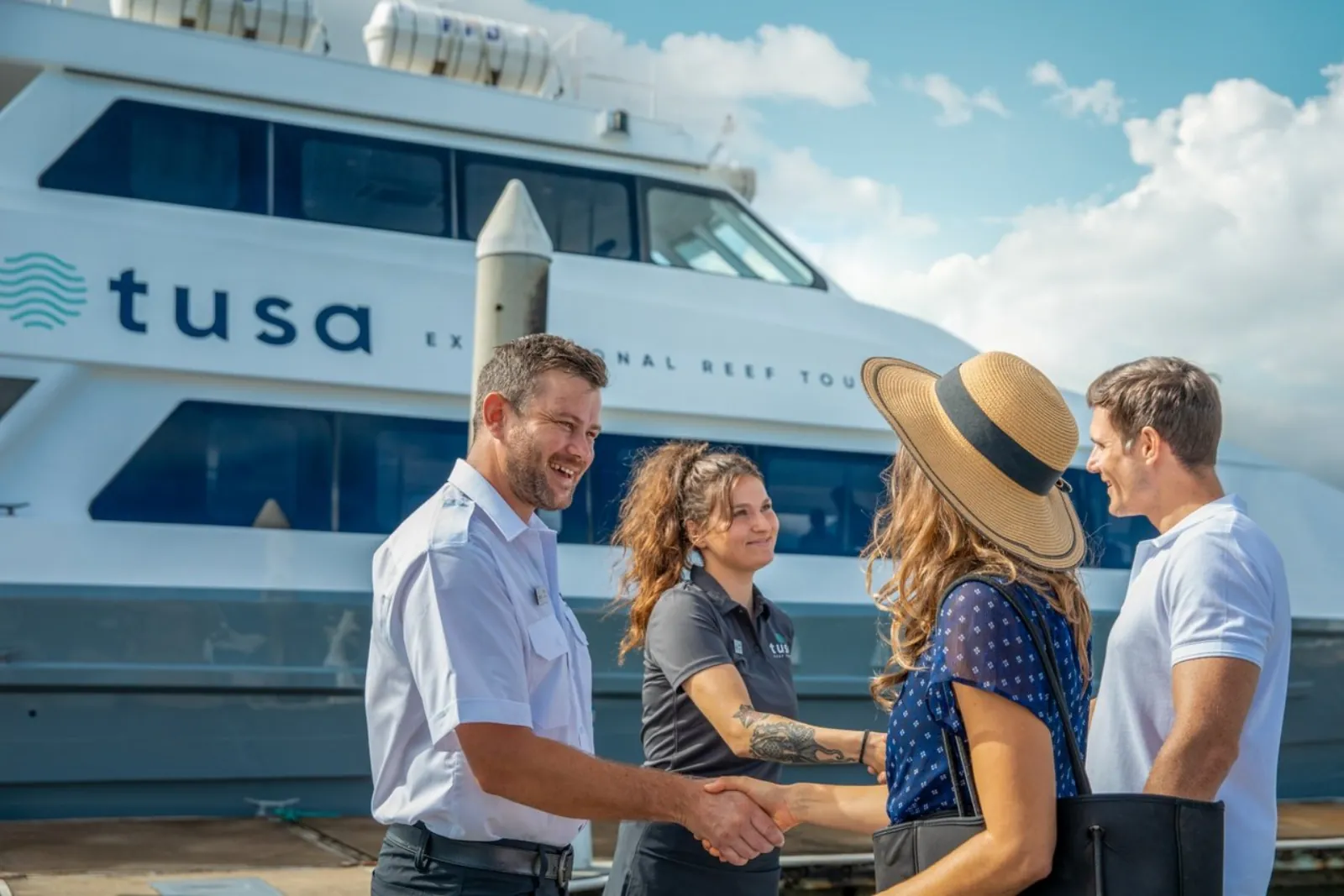 Crew welcoming guests aboard the boat at the marina