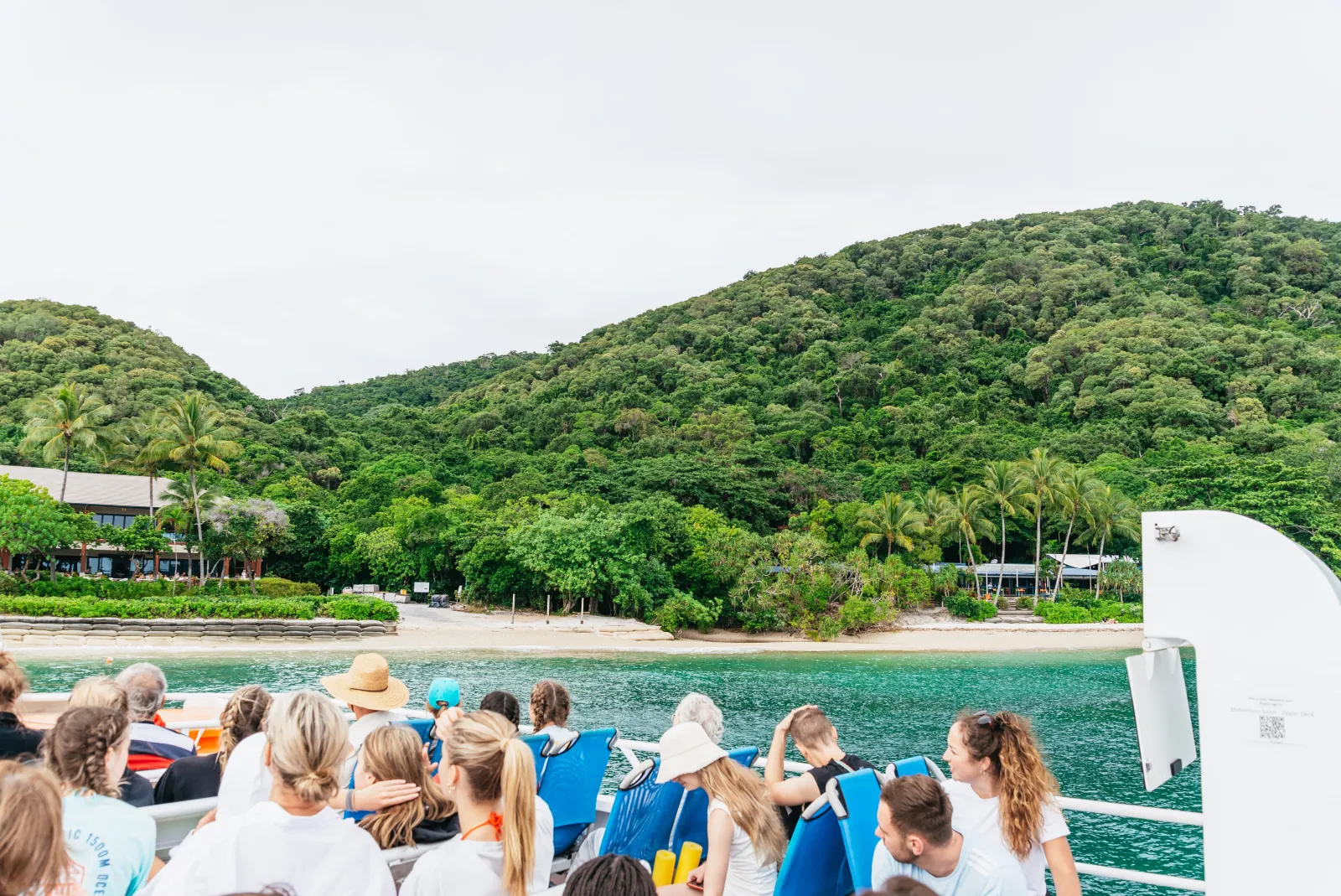 Guests on the ferry with Fitzroy Island green hills ahead