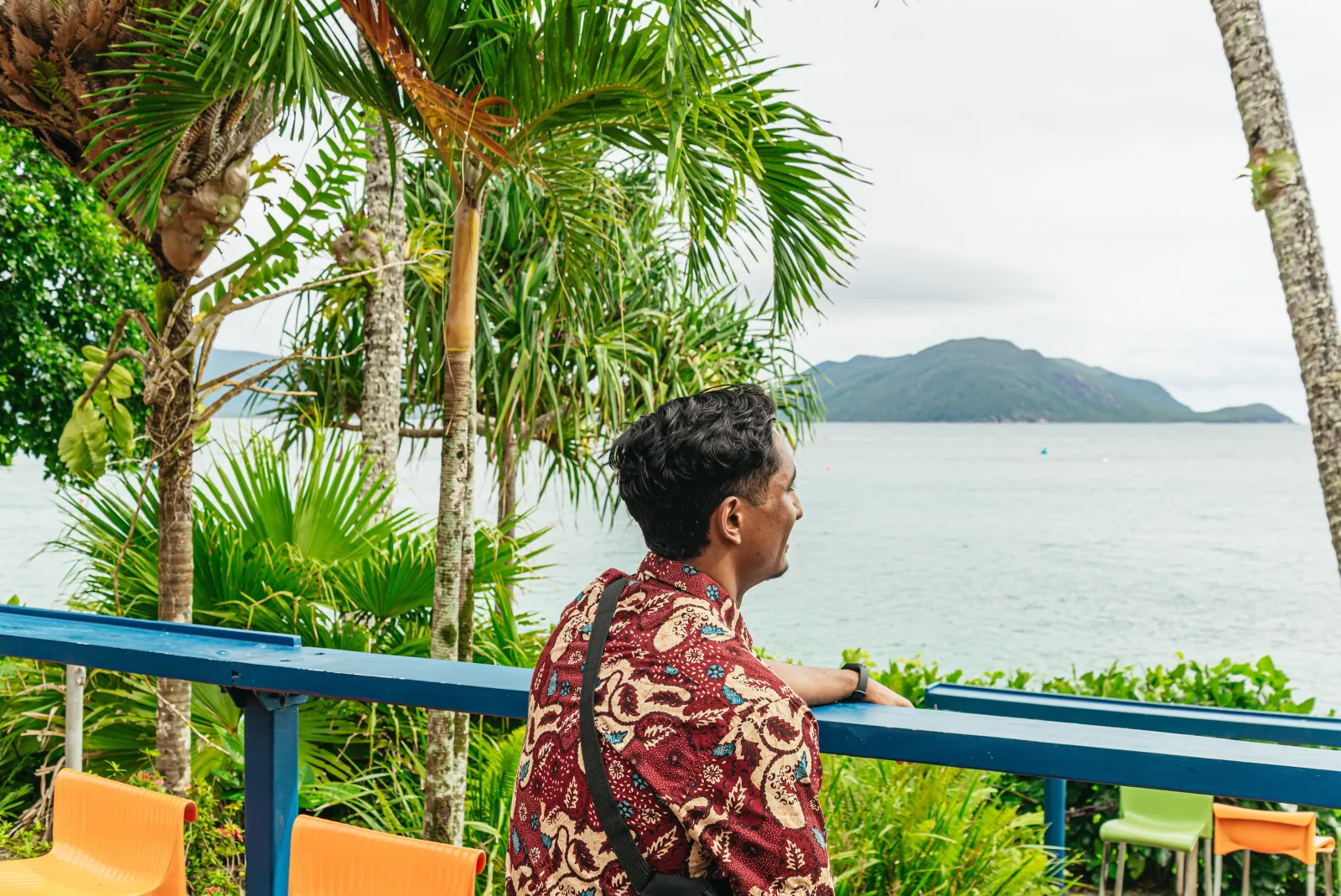 Visitor on a balcony looking out over the bay