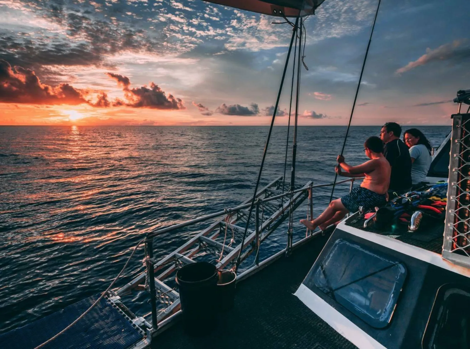 Guests on deck at sunset on the liveaboard