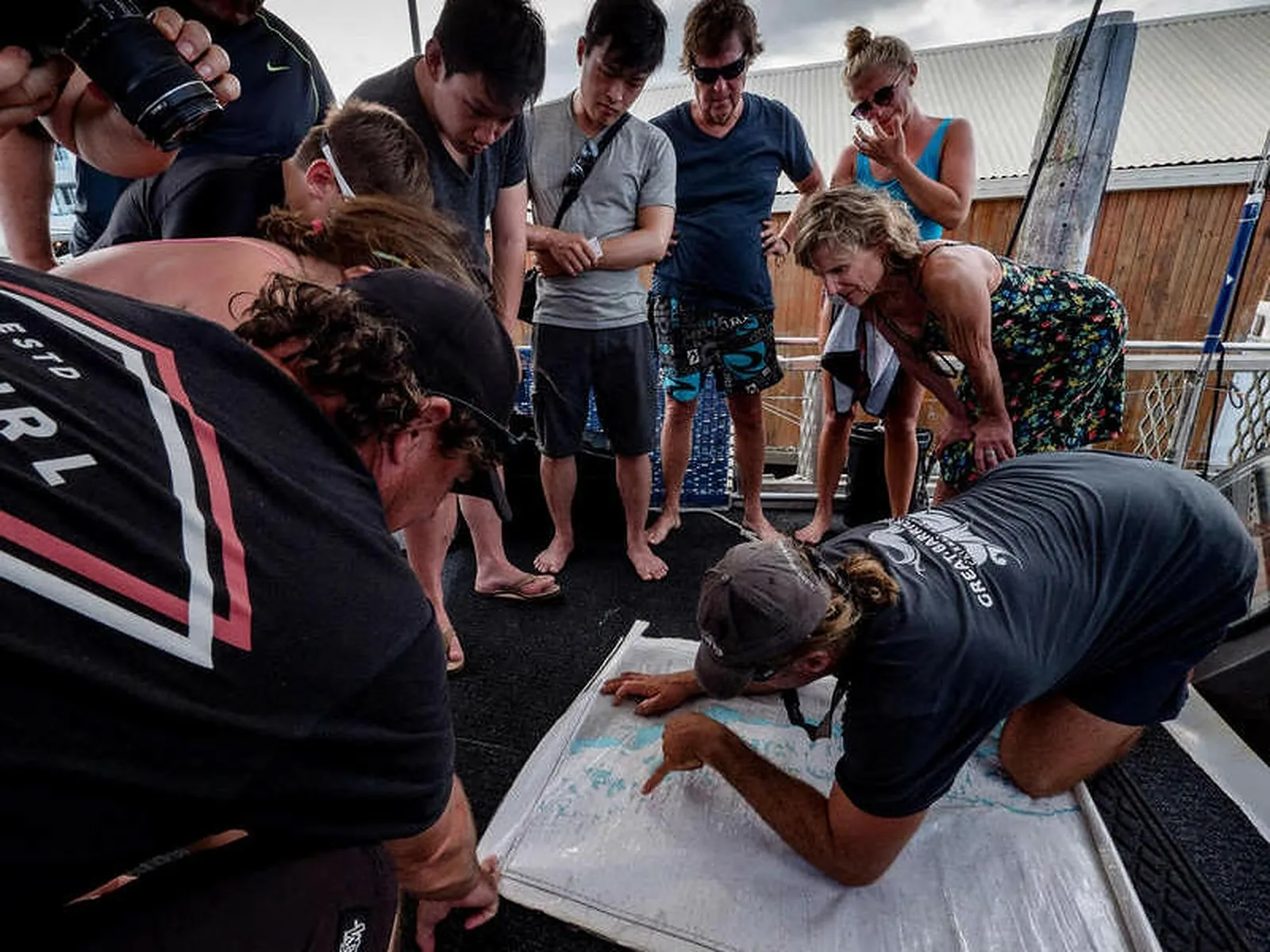Divers gathered around a dive-site briefing map