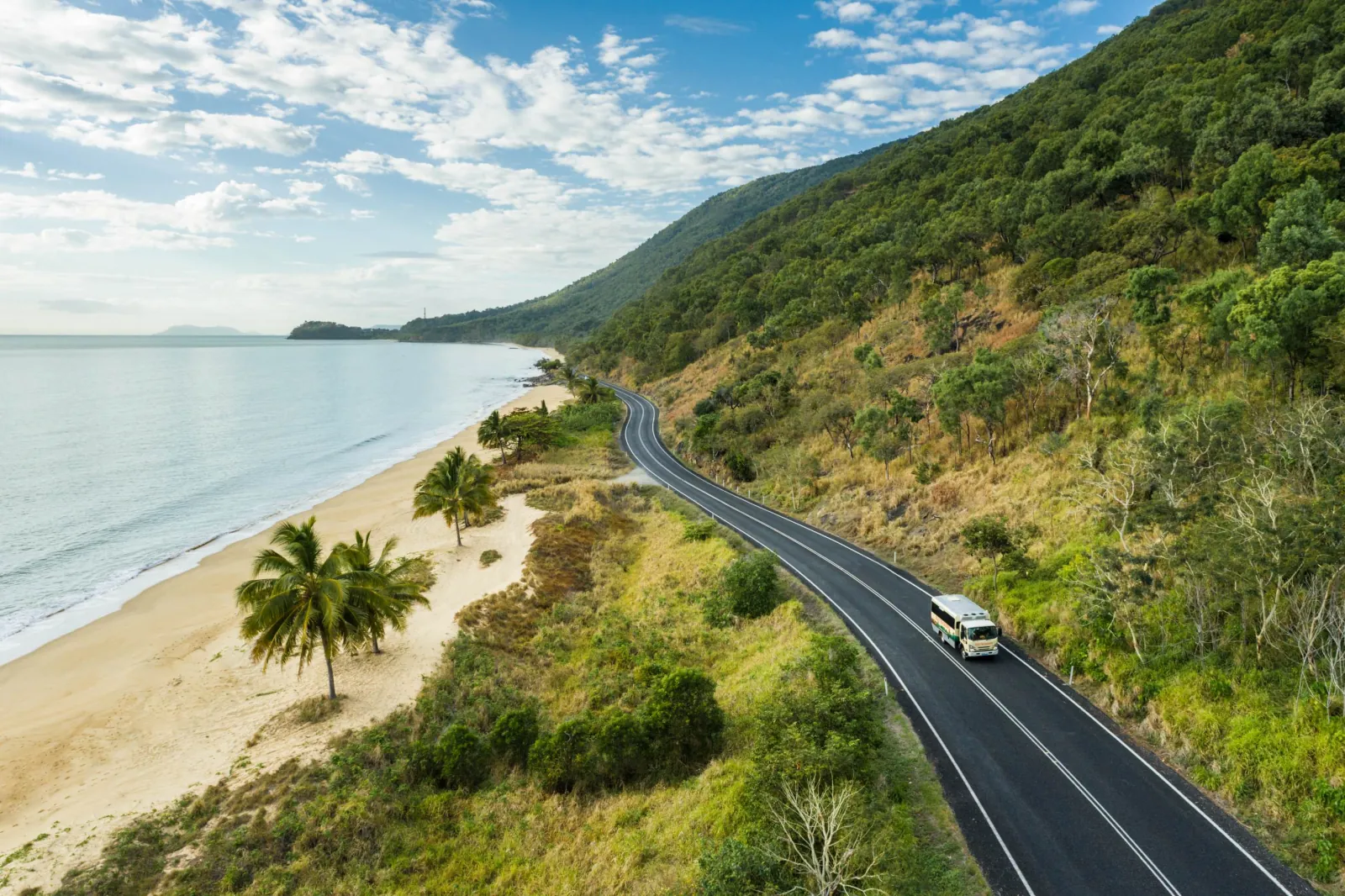 Coastal road winding along the beach north of Cairns