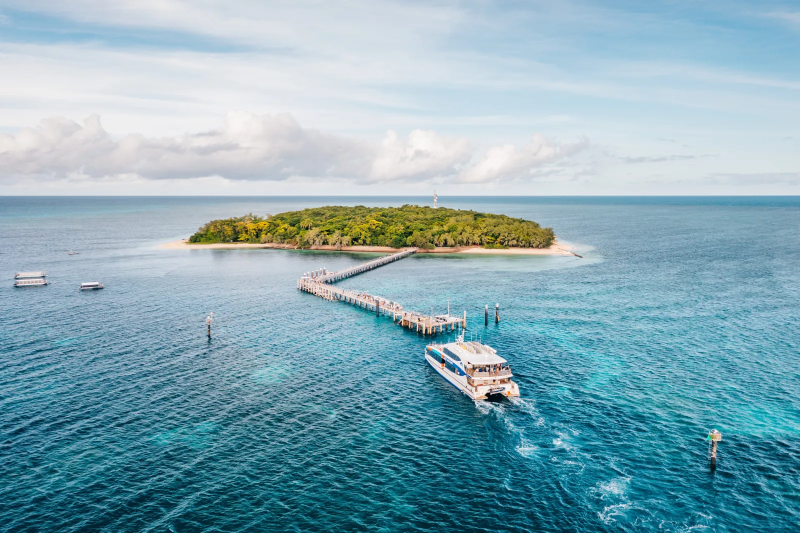 Aerial view of Green Island with a boat at its jetty
