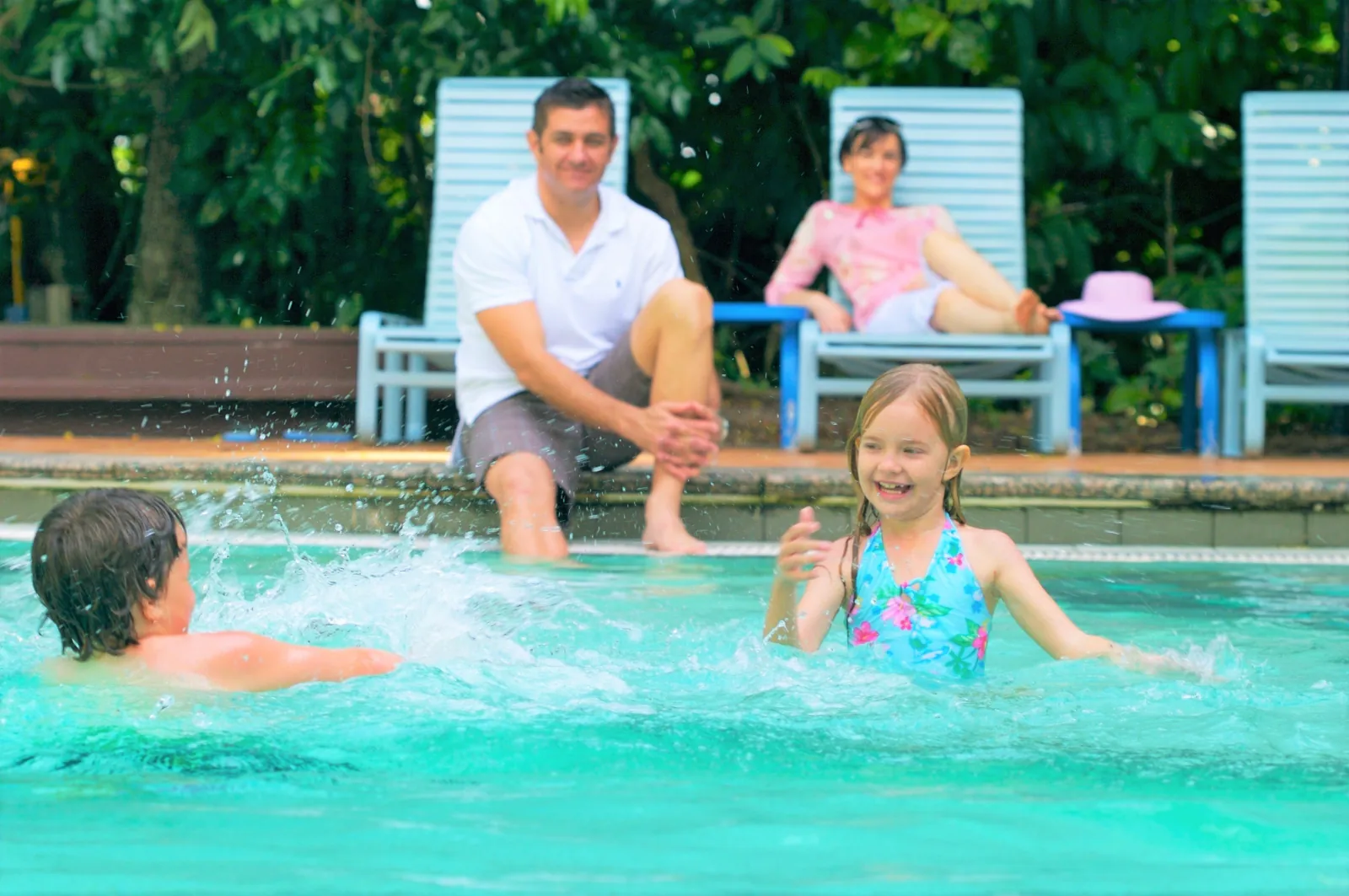 Family in the island swimming pool