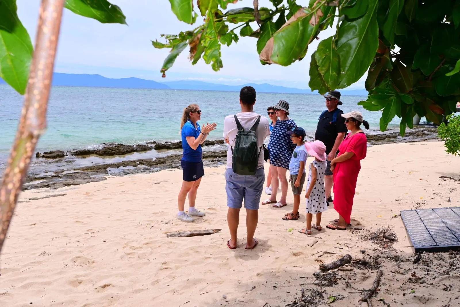 Guide leading visitors along the beach