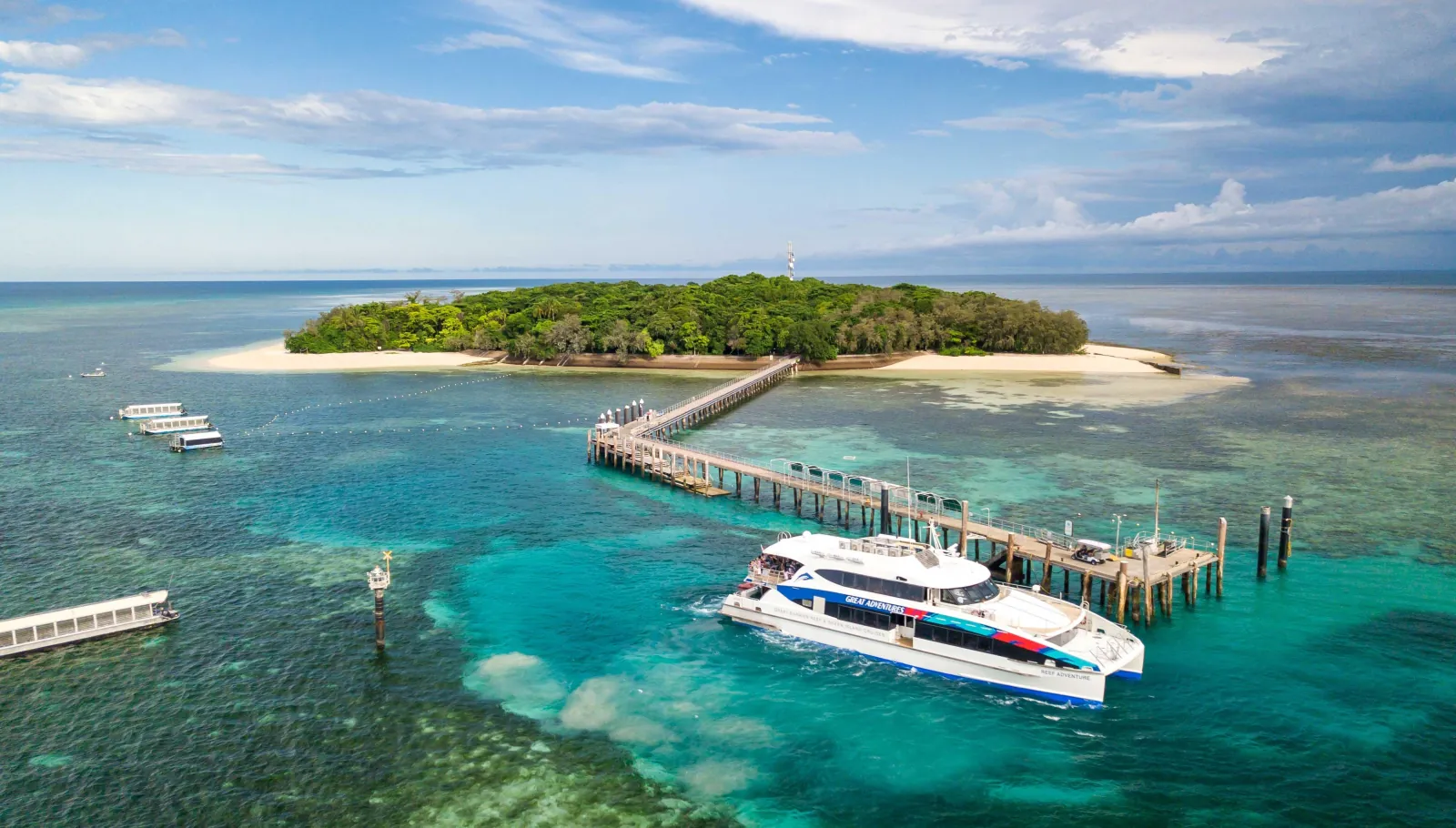 Aerial view of Green Island and its jetty with a catamaran