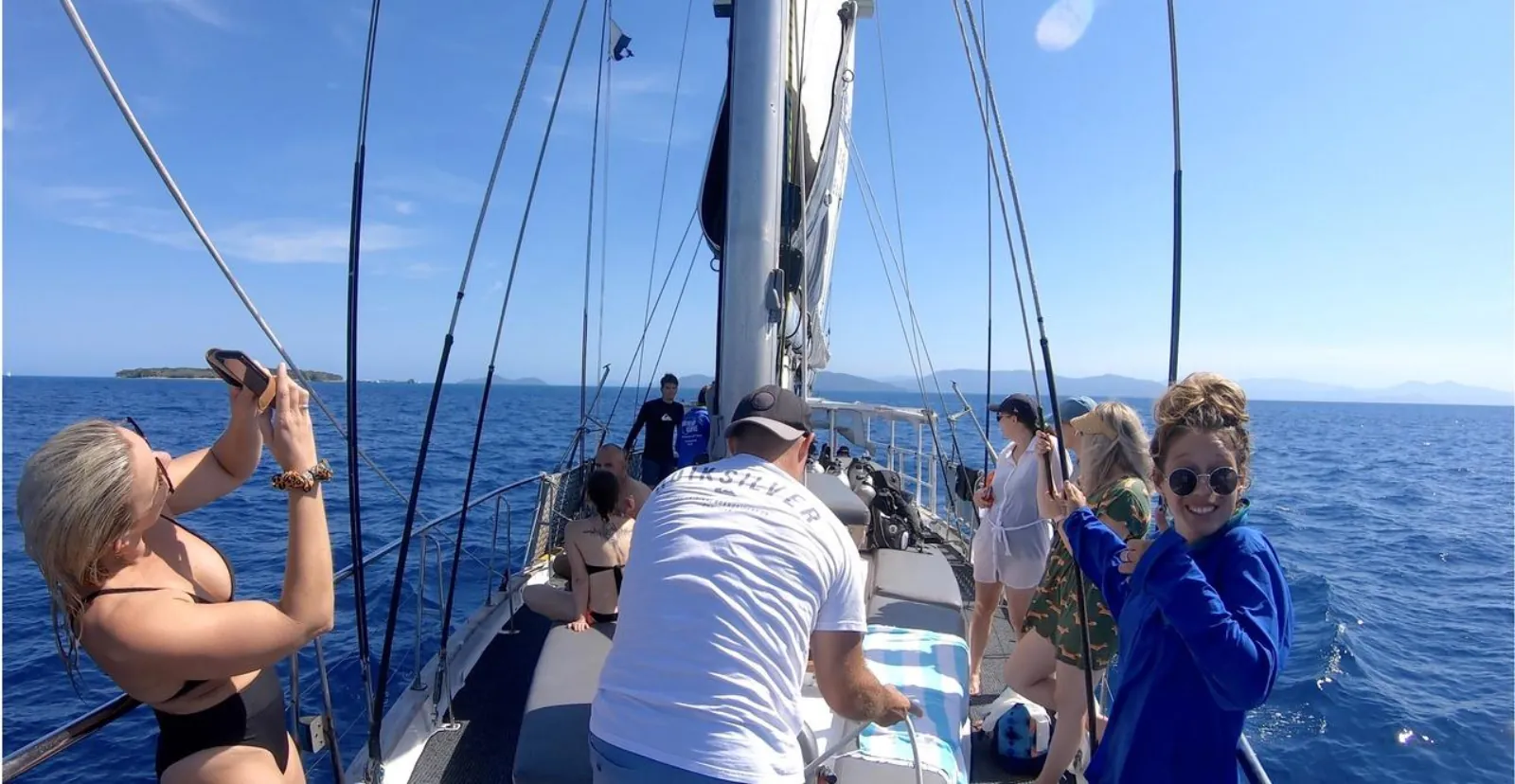 Guests hoisting the sails on deck