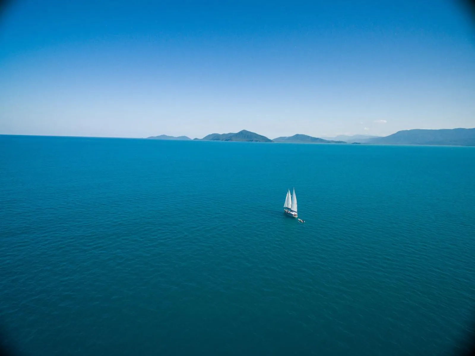 Yacht sailing across a deep blue sea