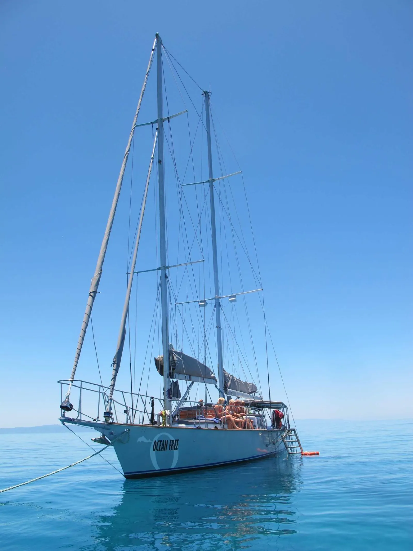 Tall-masted sailing boat at anchor