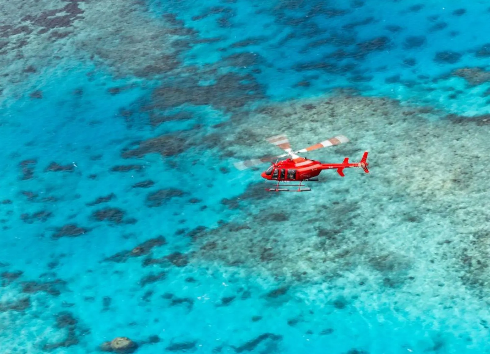 Helicopter over shallow turquoise reef
