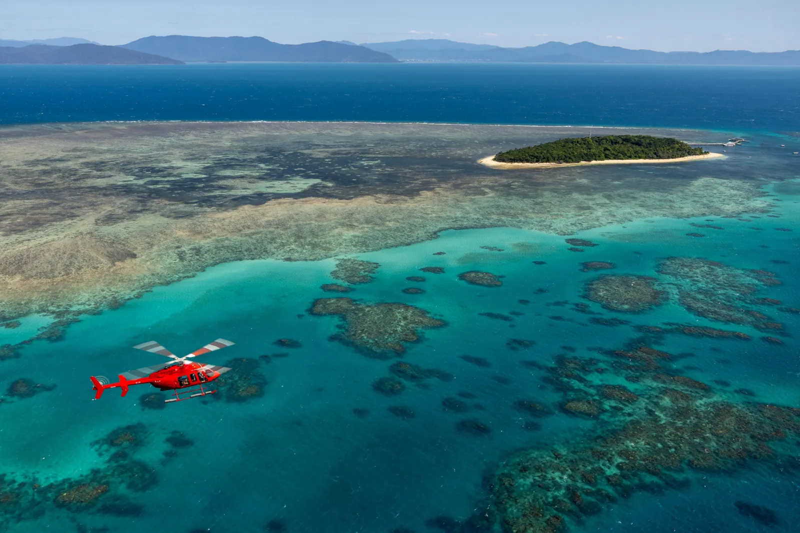 Helicopter passing an island reef