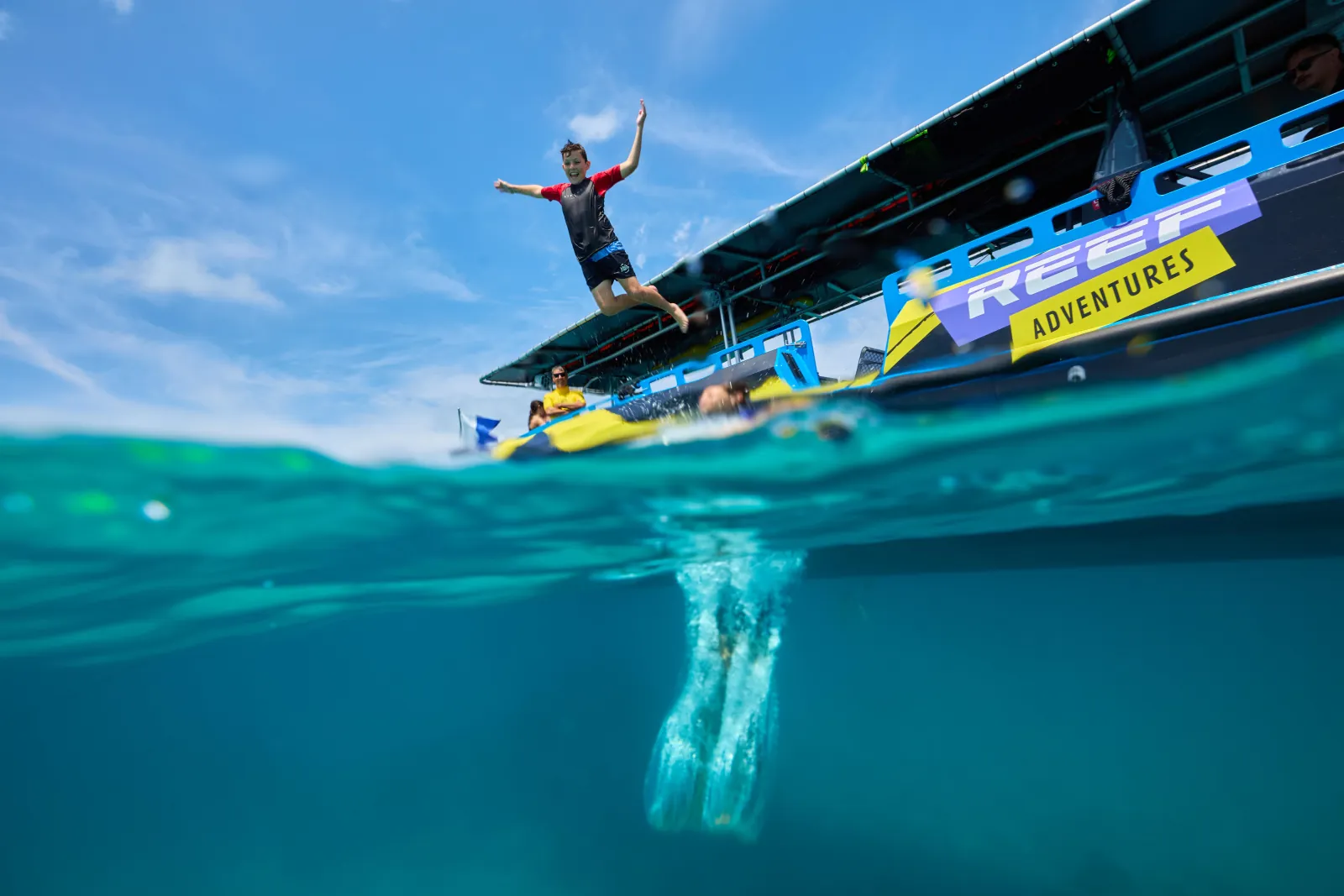 Guest jumping from the fast boat into the water