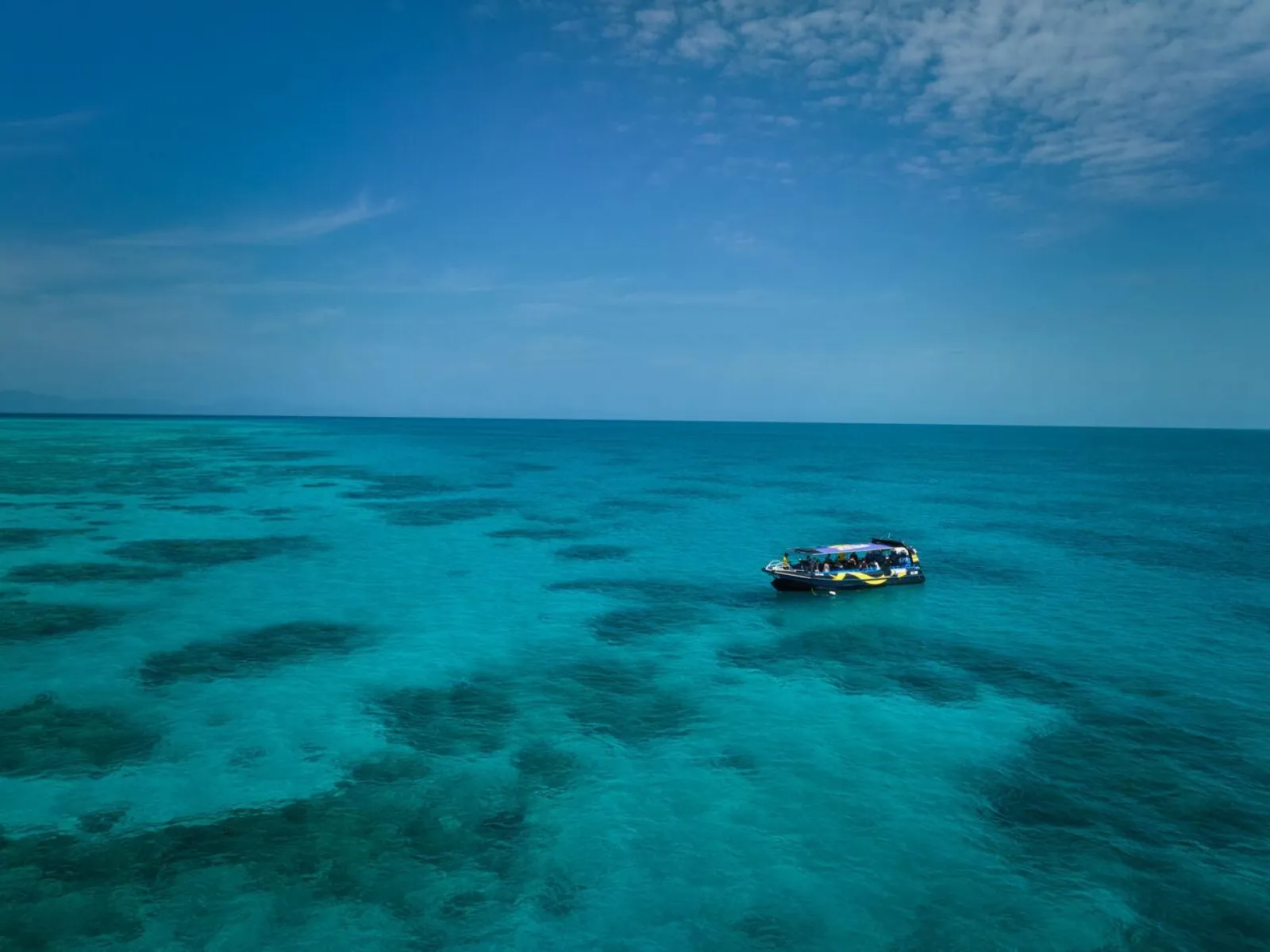 Fast boat anchored at an outer reef site