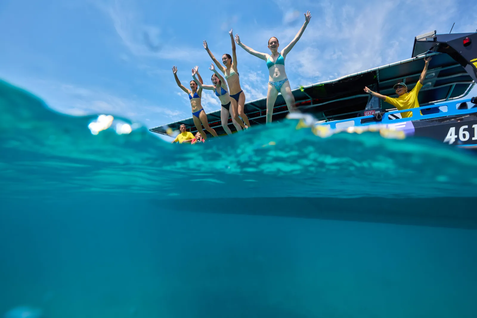 Guests posing on the bow of the boat at the reef